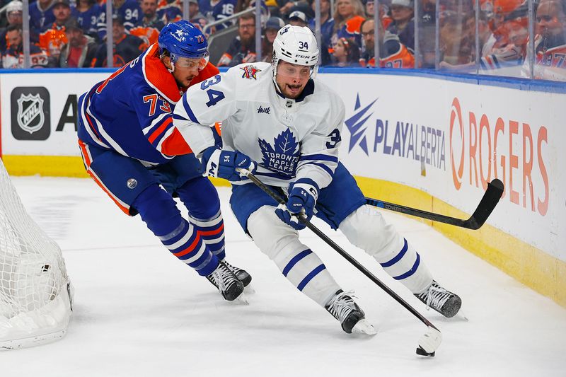 Jan 16, 2024; Edmonton, Alberta, CAN; Toronto Maple Leafs forward Auston Matthews (34) protects the puck from from Edmonton Oilers defensemen Vincent Desharnais (73) during the second period at Rogers Place. Mandatory Credit: Perry Nelson-USA TODAY Sports