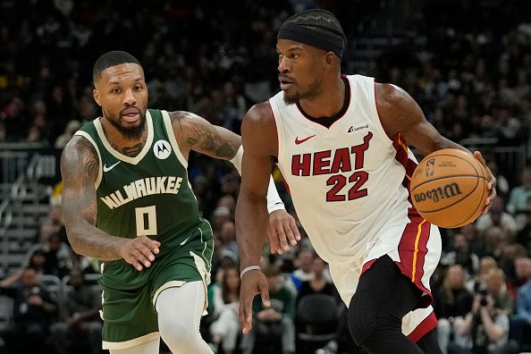 MILWAUKEE, WISCONSIN - OCTOBER 30: Jimmy Butler #22 of the Miami Heat dribbles the ball against Damian Lillard #0 of the Milwaukee Bucks during the second half at Fiserv Forum on October 30, 2023 in Milwaukee, Wisconsin. NOTE TO USER: User expressly acknowledges and agrees that, by downloading and or using this photograph, User is consenting to the terms and conditions of the Getty Images License Agreement. (Photo by Patrick McDermott/Getty Images)