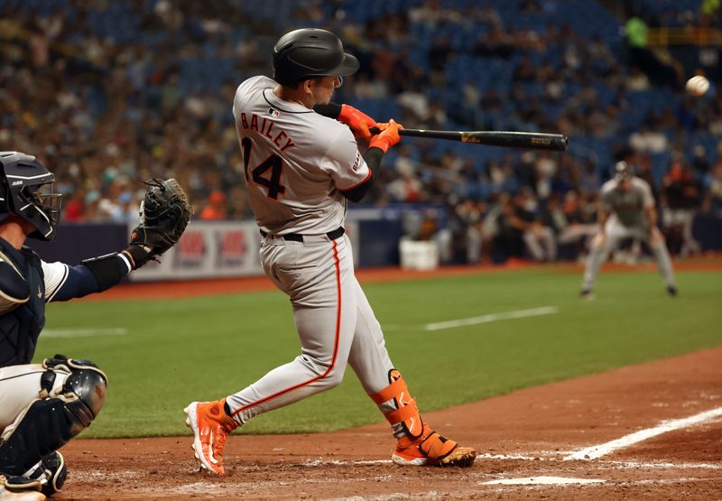 Apr 12, 2024; St. Petersburg, Florida, USA; San Francisco Giants catcher Patrick Bailey (14) singles during the seventh inning against the Tampa Bay Rays at Tropicana Field. Mandatory Credit: Kim Klement Neitzel-USA TODAY Sports