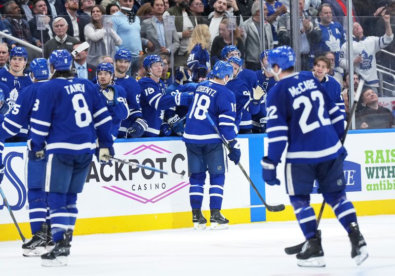 Nov 5, 2024; Toronto, Ontario, CAN; Toronto Maple Leafs center Steven Lorentz (18) celebrates at the bench after scoring an empty net goal against the Boston Bruins during the third period at Scotiabank Arena. Mandatory Credit: Nick Turchiaro-Imagn Imagess