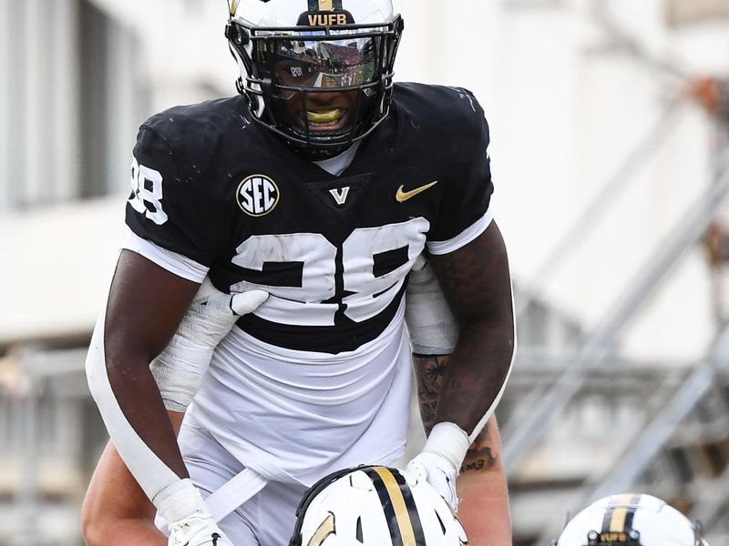 Oct 14, 2023; Nashville, Tennessee, USA; Vanderbilt Commodores running back Sedrick Alexander (28) celebrates with offensive lineman Gunnar Hansen (55) after a touchdown during the second half against the Georgia Bulldogs at FirstBank Stadium. Mandatory Credit: Christopher Hanewinckel-USA TODAY Sports