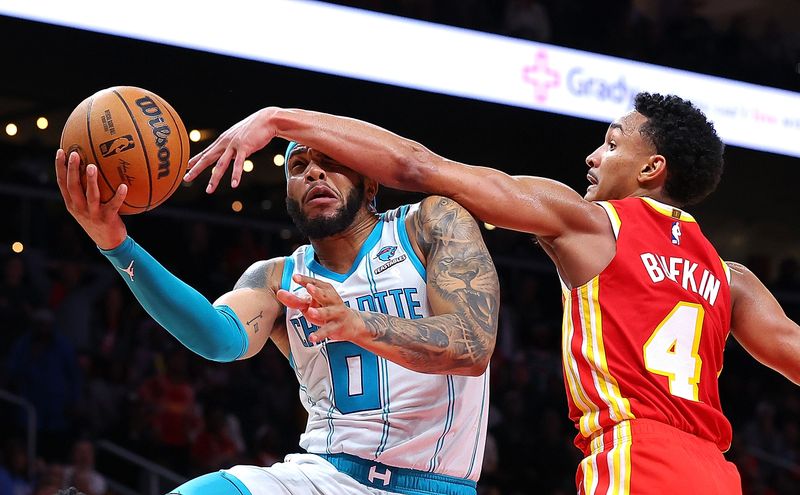 ATLANTA, GEORGIA - APRIL 10:  Miles Bridges #0 of the Charlotte Hornets scores the game-winning basket as he drives against Kobe Bufkin #4 of the Atlanta Hawks during the fourth quarter at State Farm Arena on April 10, 2024 in Atlanta, Georgia.  NOTE TO USER: User expressly acknowledges and agrees that, by downloading and/or using this photograph, user is consenting to the terms and conditions of the Getty Images License Agreement.  (Photo by Kevin C. Cox/Getty Images)