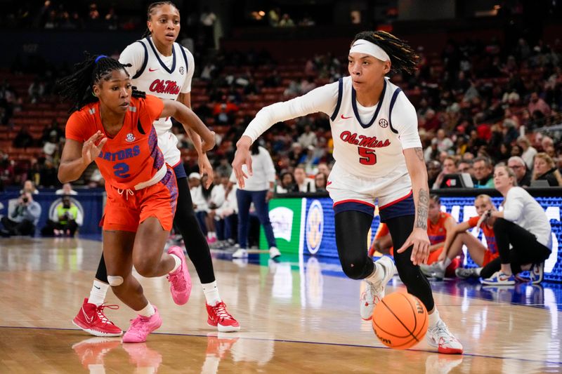 Mar 8, 2024; Greensville, SC, USA; Ole Miss Rebels forward Snudda Collins (5) drives to the basket against Florida Gators guard Aliyah Matharu (2) during the first half at Bon Secours Wellness Arena. Mandatory Credit: Jim Dedmon-USA TODAY Sports