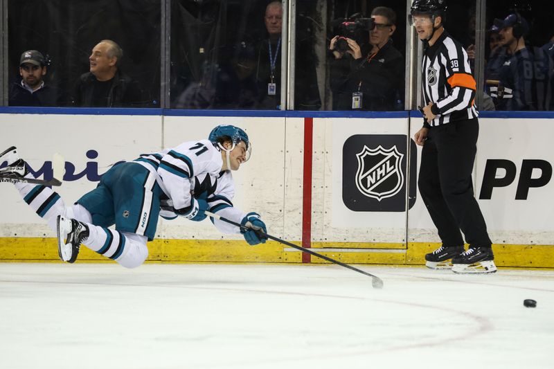 Oct 23, 2025; New York, New York, USA;  San Jose Sharks center Macklin Celebrini (71) falls to the ice chasing the puck in the second period against the New York Rangers at Madison Square Garden. Mandatory Credit: Wendell Cruz-Imagn Images