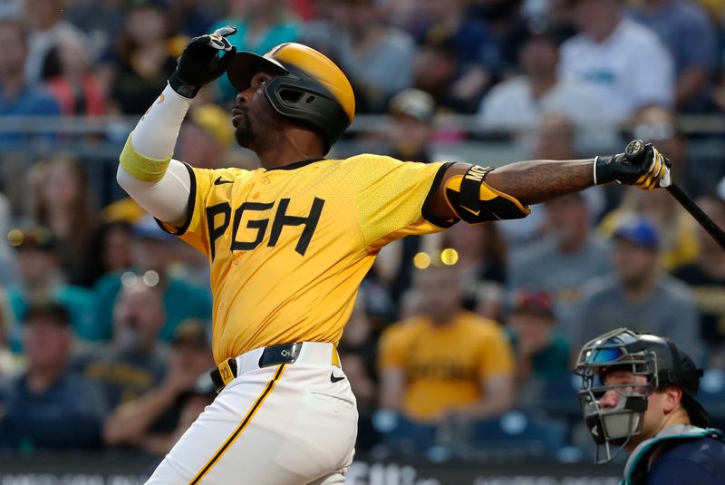 Aug 16, 2024; Pittsburgh, Pennsylvania, USA;  Pittsburgh Pirates designated hitter Andrew McCutchen (22) drives in a run with a sacrifice fly against the Seattle Mariners during the fifth inning at PNC Park. Mandatory Credit: Charles LeClaire-USA TODAY Sports