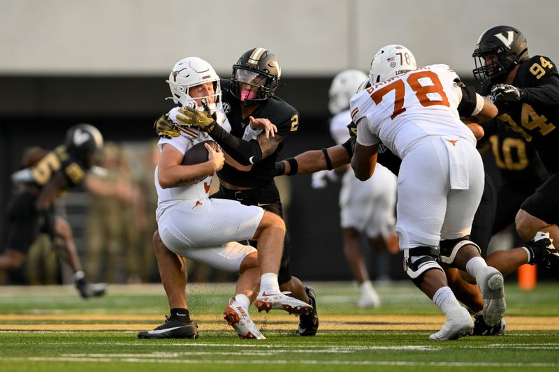 Oct 26, 2024; Nashville, Tennessee, USA;  Vanderbilt Commodores linebacker Randon Fontenette (2) sacks Texas Longhorns quarterback Quinn Ewers (3) during the first half at FirstBank Stadium. Mandatory Credit: Steve Roberts-Imagn Images