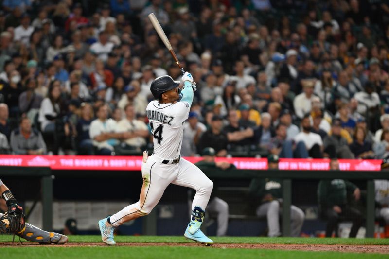 Aug 28, 2023; Seattle, Washington, USA; Seattle Mariners center fielder Julio Rodriguez (44) hits a 2-run home run against the Oakland Athletics during the third inning at T-Mobile Park. Mandatory Credit: Steven Bisig-USA TODAY Sports