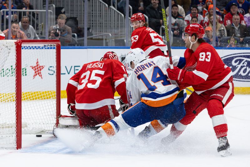 Oct 30, 2023; Elmont, New York, USA; New York Islanders center Bo Horvat (14) follows the puck into the net after New York Islanders center Casey Cizikas (53) (not seen) scored against the Detroit Red Wings during the second period at UBS Arena. Mandatory Credit: Thomas Salus-USA TODAY Sports