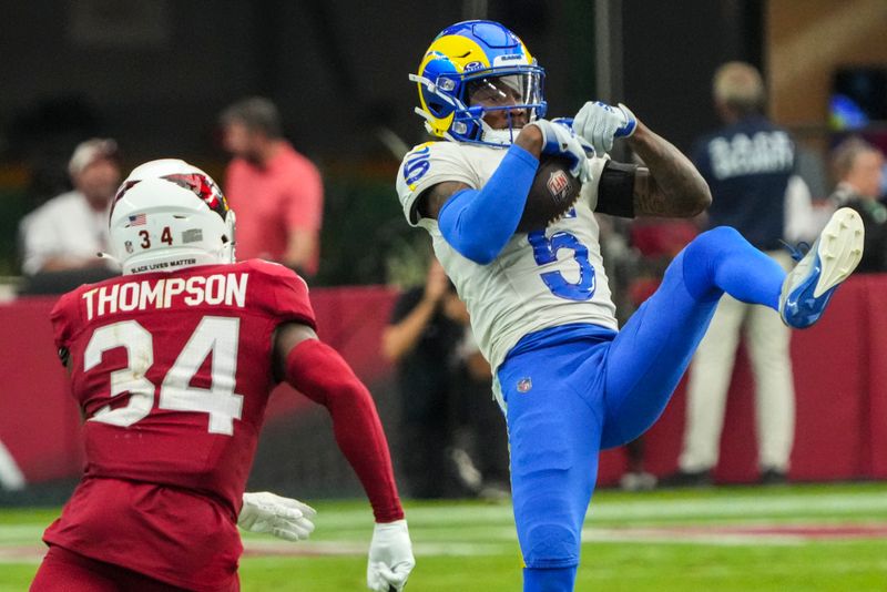 Los Angeles Rams wide receiver Tutu Atwell (5) makes a catch against Arizona Cardinals safety Jalen Thompson (34) during the second half of an NFL football game, Sunday, Sept. 15, 2024, in Glendale, Ariz. (AP Photo/Rick Scuteri)