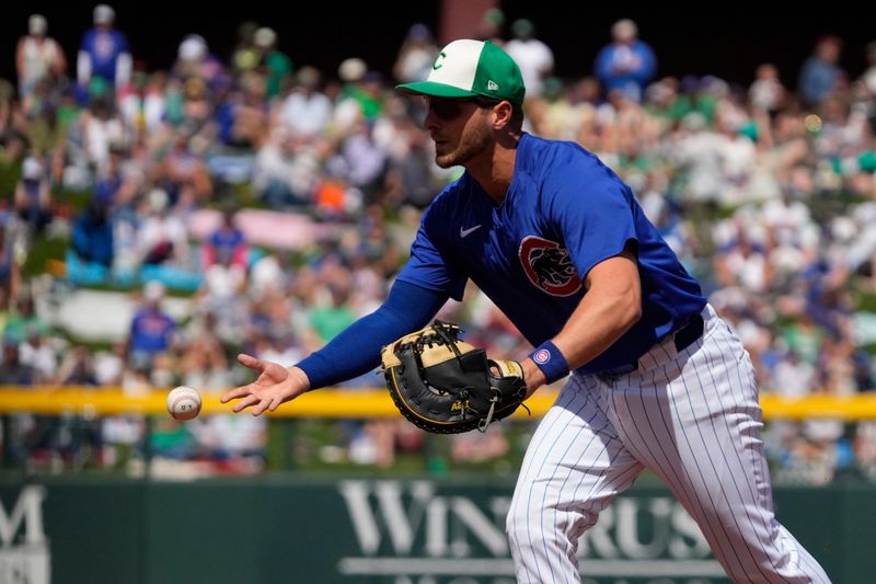 Mar 17, 2024; Mesa, Arizona, USA; Chicago Cubs first baseman Michael Busch makes the play for an out against the Texas Rangers in the second inning at Sloan Park. Mandatory Credit: Rick Scuteri-USA TODAY Sports