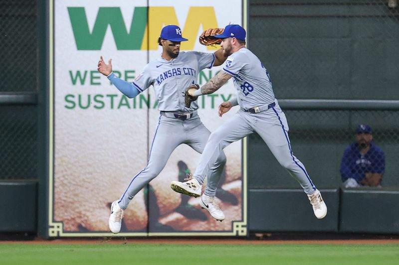 Aug 31, 2024; Houston, Texas, USA; Kansas City Royals left fielder MJ Melendez (1) attempts to avoid a collision with center fielder Kyle Isbel (28) after Isbel catches a fly ball during the fourth inning against the Houston Astros at Minute Maid Park. Mandatory Credit: Troy Taormina-USA TODAY Sports
