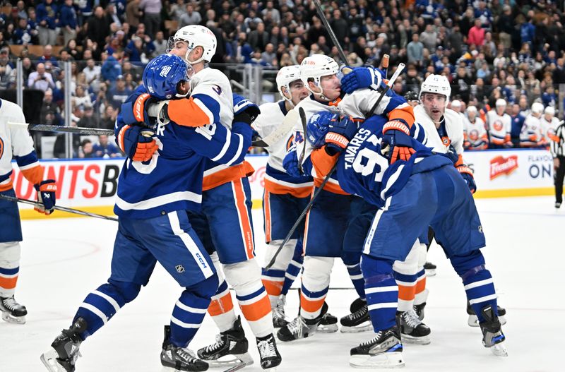 Feb 5, 2024; Toronto, Ontario, CAN; Players from the New York Islanders and Toronto Maple Leafs fight at the end of the Islanders 3-2 win at Scotiabank Arena. Mandatory Credit: Dan Hamilton-USA TODAY Sports