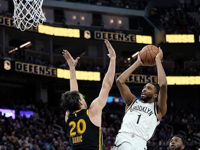 SAN FRANCISCO, CALIFORNIA - DECEMBER 16: Mikal Bridges #1 of the Brooklyn Nets shoots over Dario Saric #20 of the Golden State Warriors during the fourth quarter of an NBA basketball game at Chase Center on December 16, 2023 in San Francisco, California. NOTE TO USER: User expressly acknowledges and agrees that, by downloading and or using this photograph, User is consenting to the terms and conditions of the Getty Images License Agreement. (Photo by Thearon W. Henderson/Getty Images)