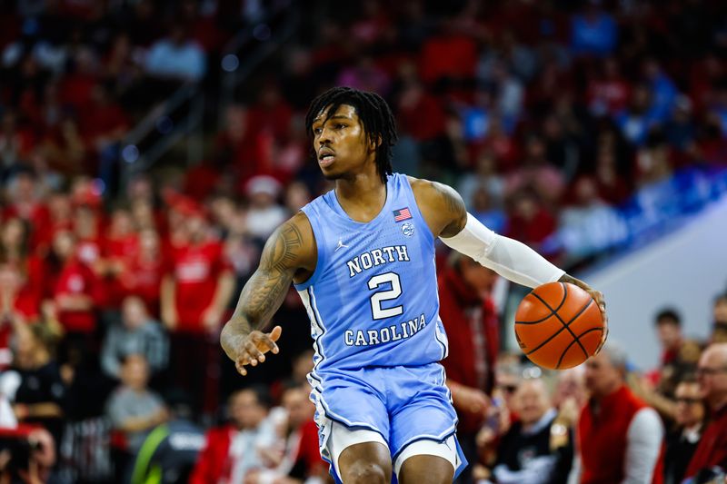 Feb 19, 2023; Raleigh, North Carolina, USA;  North Carolina Tar Heels guard Caleb Love (2) dribbles during the second half of the game against North Carolina State Wolfpack at PNC Arena. Mandatory Credit: Jaylynn Nash-USA TODAY Sports