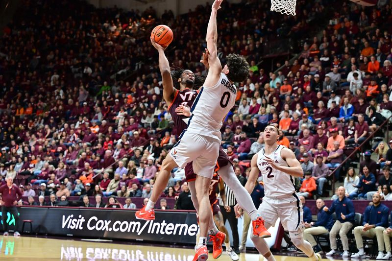 Feb 15, 2025; Blacksburg, Virginia, USA;  Virginia Tech Hokies forward Mylyjael Poteat (34) shoots the ball as Virginia Cavaliers forward Blake Buchanan (0) defends during the first half at Cassell Coliseum. Mandatory Credit: Brian Bishop-Imagn Images