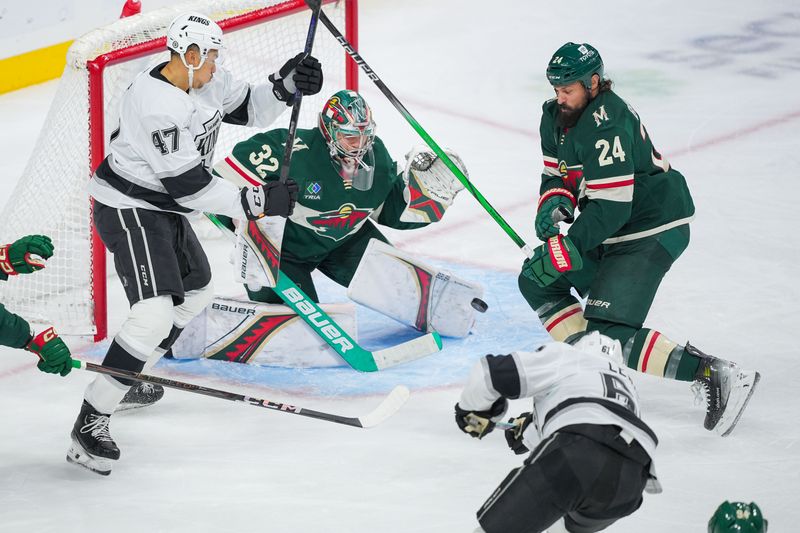 Nov 5, 2024; Saint Paul, Minnesota, USA; Los Angeles Kings center Trevor Lewis (61) scores against the Minnesota Wild goaltender Filip Gustavsson (32) in the third period at Xcel Energy Center. Mandatory Credit: Brad Rempel-Imagn Images