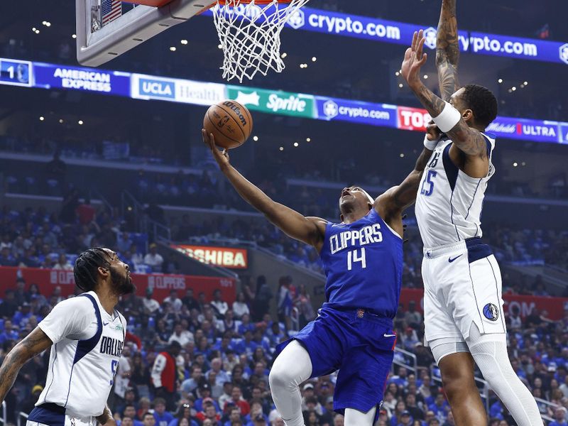 LOS ANGELES, CALIFORNIA - APRIL 21:  Terance Mann #14 of the LA Clippers takes a shot against P.J. Washington #25 of the Dallas Mavericks in the first half during game one of the Western Conference First Round Playoffs at Crypto.com Arena on April 21, 2024 in Los Angeles, California.   NOTE TO USER: User expressly acknowledges and agrees that, by downloading and/or using this photograph, user is consenting to the terms and conditions of the Getty Images License Agreement.  (Photo by Ronald Martinez/Getty Images)