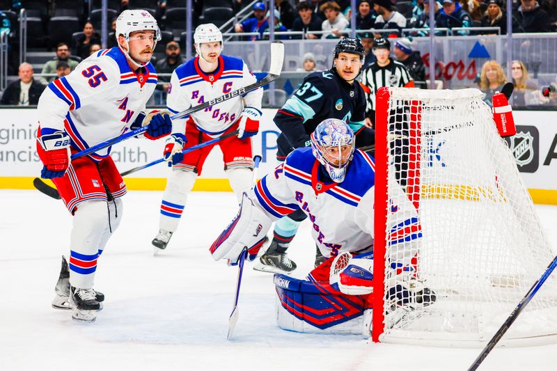 Nov 17, 2024; Seattle, Washington, USA; New York Rangers goaltender Jonathan Quick (32) and defenseman Ryan Lindgren (55) protect the net against the Seattle Kraken during the first period at Climate Pledge Arena. Seattle Kraken center Yanni Gourde (37) follows the play at right. Mandatory Credit: Joe Nicholson-Imagn Images