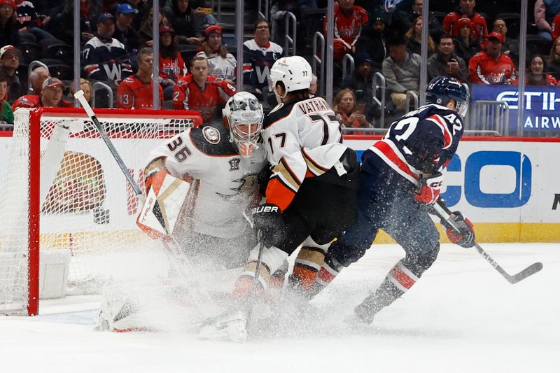 Jan 16, 2024; Washington, District of Columbia, USA; Washington Capitals defenseman Martin Fehervary (42) and Anaheim Ducks right wing Frank Vatrano (77) collide with Ducks goaltender John Gibson (36) in the first period at Capital One Arena. Mandatory Credit: Geoff Burke-USA TODAY Sports