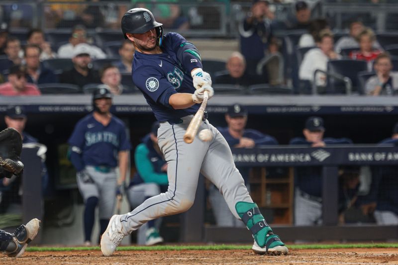 May 21, 2024; Bronx, New York, USA;Seattle Mariners first baseman Ty France (23) hits a broken bat infield single during the eighth inning against the New York Yankees at Yankee Stadium. Mandatory Credit: Vincent Carchietta-USA TODAY Sports