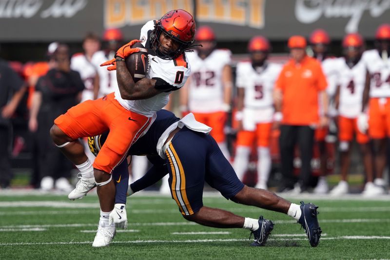 Oct 26, 2024; Berkeley, California, USA; Oregon State Beavers running back Anthony Hankerson (0) carries the ball against California Golden Bears defensive back Craig Woodson (right) during the second quarter at California Memorial Stadium. Mandatory Credit: Darren Yamashita-Imagn Images