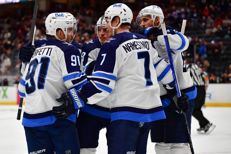 Jan 5, 2024; Anaheim, California, USA; Winnipeg Jets celebrate the goal scored by center Cole Perfetti (91) against the Anaheim Ducks during the third period at Honda Center. Mandatory Credit: Gary A. Vasquez-USA TODAY Sports