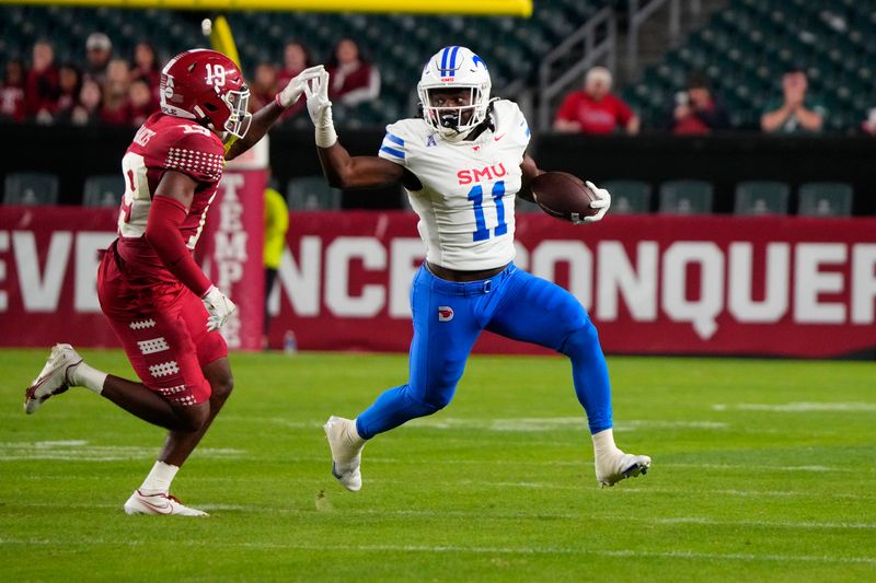 Oct 20, 2023; Philadelphia, Pennsylvania, USA; SMU Mustangs running back LJ Johnson Jr. (11) straight arms Temple Owls safety Tywan Francis (19) while running with the ball during the first half at Lincoln Financial Field. Mandatory Credit: Gregory Fisher-USA TODAY Sports