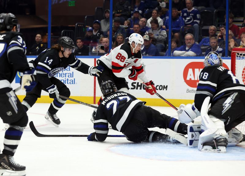 Oct 11, 2025; Tampa, Florida, USA; New Jersey Devils center Jack Hughes (86) skates with the puck as Tampa Bay Lightning center Conor Geekie (14) defends during the second period at Benchmark International Arena. Mandatory Credit: Kim Klement Neitzel-Imagn Images