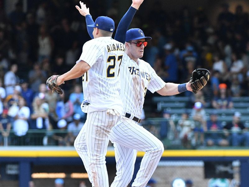 Aug 27, 2023; Milwaukee, Wisconsin, USA; Milwaukee Brewers shortstop Willy Adames (27) and Milwaukee Brewers left fielder Mark Canha (21) celebrate a 10-6 win over the San Diego Padres at American Family Field. Mandatory Credit: Michael McLoone-USA TODAY Sports