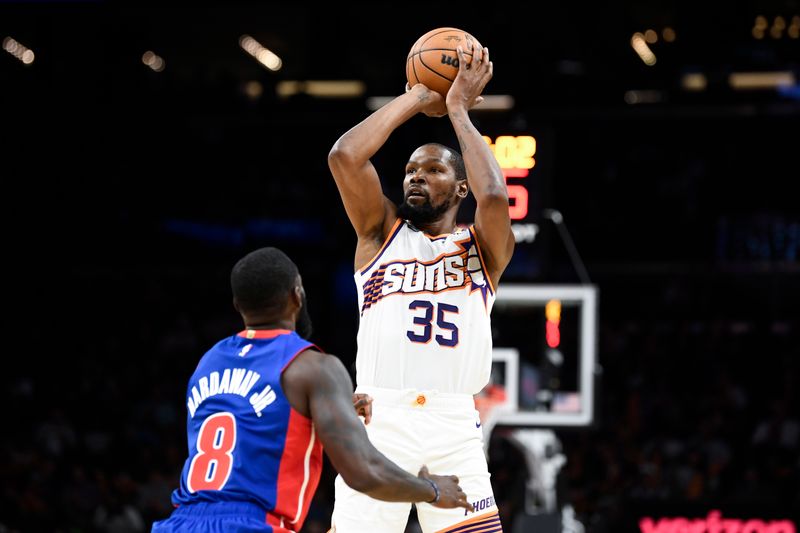 PHOENIX, ARIZONA - OCTOBER 11: Kevin Durant #35 of the Phoenix Suns takes a shot against Tim Hardaway Jr. #8 of the Detroit Pistons during the second half of the preseason game at Footprint Center on October 11, 2024 in Phoenix, Arizona.  NOTE TO USER: User expressly acknowledges and agrees that, by downloading and/or using this photograph, user is consenting to the terms and conditions of the Getty Images License Agreement. (Photo by Kelsey Grant/Getty Images)