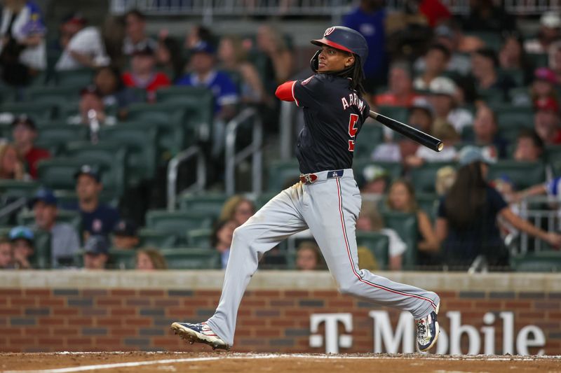 Aug 24, 2024; Atlanta, Georgia, USA; Washington Nationals shortstop CJ Abrams (5) hits a single against the Atlanta Braves in the fifth inning at Truist Park. Mandatory Credit: Brett Davis-USA TODAY Sports