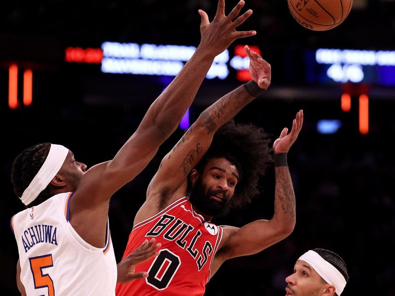 NEW YORK, NEW YORK - JANUARY 03: Coby White #0 of the Chicago Bulls passes the ball as Precious Achiuwa #5 and Josh Hart #3 of the New York Knicks defend during the second half at Madison Square Garden on January 03, 2024 in New York City. The New York Knicks defeated the Chicago Bulls 116-100. NOTE TO USER: User expressly acknowledges and agrees that, by downloading and or using this photograph, User is consenting to the terms and conditions of the Getty Images License Agreement. (Photo by Elsa/Getty Images)