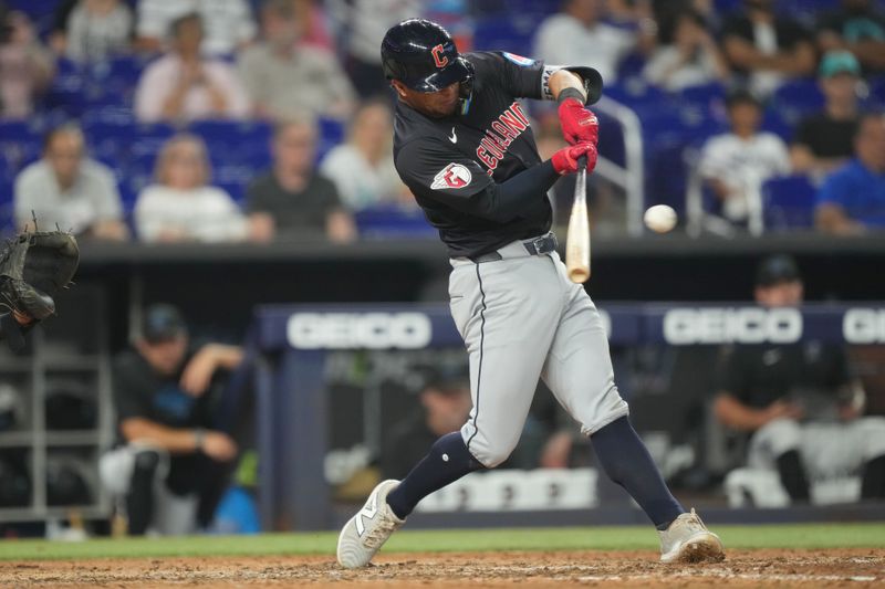 Jun 9, 2024; Miami, Florida, USA; Cleveland Guardians center fielder Tyler Freeman (2) hits a single against the Miami Marlins in the ninth inning at loanDepot Park. Mandatory Credit: Jim Rassol-USA TODAY Sports