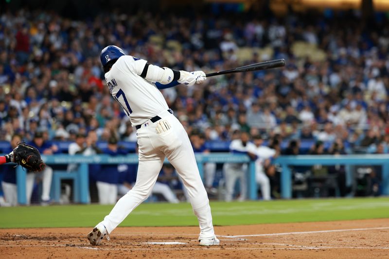 May 17, 2024; Los Angeles, California, USA;  Los Angeles Dodgers designated hitter Shohei Ohtani (17) hits a home run during the third inning against the Cincinnati Reds at Dodger Stadium. Mandatory Credit: Kiyoshi Mio-USA TODAY Sports