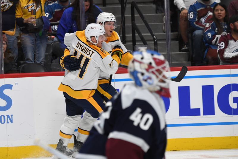 Nov 11, 2024; Denver, Colorado, USA; Nashville Predators center Colton Sissons (10) and center Gustav Nyquist (14) celebrate after a goal against Colorado Avalanche goaltender Alexandar Georgiev (40) during the third period at Ball Arena. Mandatory Credit: Christopher Hanewinckel-Imagn Images