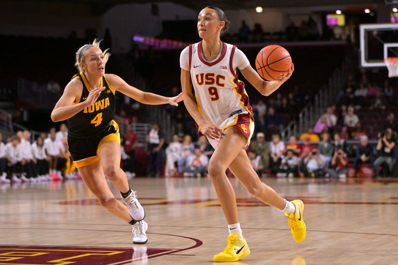 Jan 29, 2026; Los Angeles, California, USA;  USC Trojans guard Jazzy Davidson (9) is defended by Iowa Hawkeyes guard Kylie Feuerbach (4) as she drives to the basket in the first half at Galen Center. Mandatory Credit: Jayne Kamin-Oncea-Imagn Images