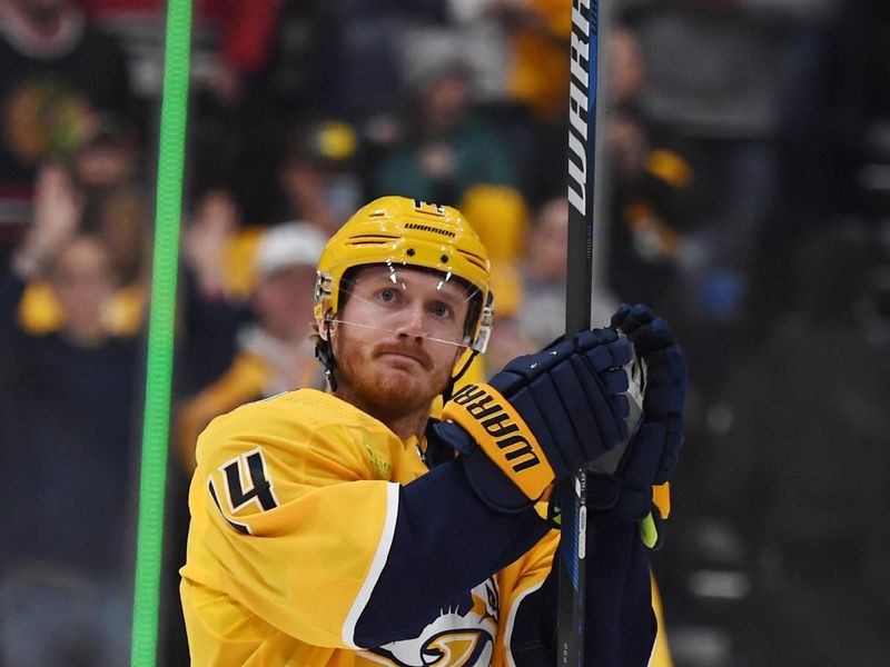 Jan 2, 2024; Nashville, Tennessee, USA; Nashville Predators center Gustav Nyquist (14) celebrates after a win against the Chicago Blackhawks at Bridgestone Arena. Mandatory Credit: Christopher Hanewinckel-USA TODAY Sports