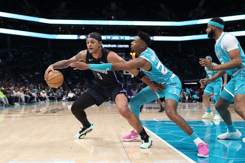 CHARLOTTE, NC - APRIL 5:  Paolo Banchero #5 of the Orlando Magic handles the ball during the game against the Charlotte Hornets on April 5, 2024 at Spectrum Center in Charlotte, North Carolina. NOTE TO USER: User expressly acknowledges and agrees that, by downloading and or using this photograph, User is consenting to the terms and conditions of the Getty Images License Agreement.  Mandatory Copyright Notice:  Copyright 2024 NBAE (Photo by Brock Williams-Smith/NBAE via Getty Images)