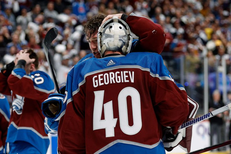 Apr 26, 2024; Denver, Colorado, USA; Colorado Avalanche right wing Brandon Duhaime (12) celebrates with goaltender Alexandar Georgiev (40) after the game against the Winnipeg Jets in game three of the first round of the 2024 Stanley Cup Playoffs at Ball Arena. Mandatory Credit: Isaiah J. Downing-USA TODAY Sports