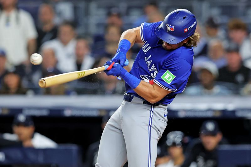 Oct 8, 2025; Bronx, New York, USA; Toronto Blue Jays third baseman Addison Barger (47) hits a single during the first inning during game four of the ALDS round for the 2025 MLB playoffs at Yankee Stadium. Mandatory Credit: Brad Penner-Imagn Images