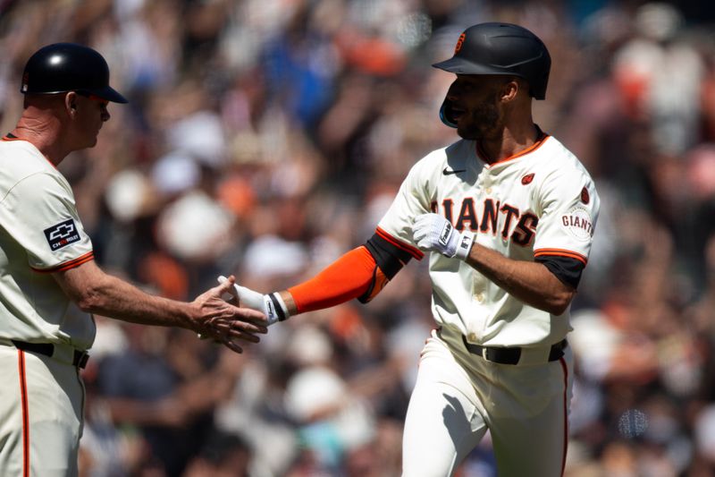 Aug 15, 2024; San Francisco, California, USA; San Francisco Giants center fielder Grant McCray (right) celebrates with third base coach Matt Williams (9) after hitting his  first major league home run during the sixth inning against the Atlanta Braves at Oracle Park. Mandatory Credit: D. Ross Cameron-USA TODAY Sports