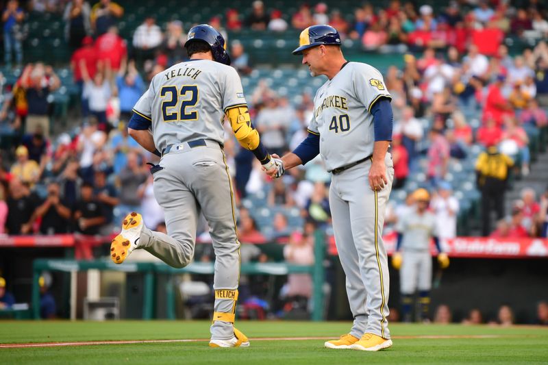 Jun 18, 2024; Anaheim, California, USA; Milwaukee Brewers outfielder Christian Yelich (22) is greeted by third base coach Jason Lane (40) after hitting a solo home run against the Los Angeles Angels during the first inning at Angel Stadium. Mandatory Credit: Gary A. Vasquez-USA TODAY Sports