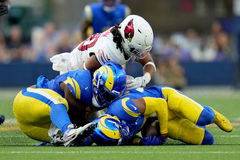 Los Angeles Rams safety Quentin Lake (37), bottom right, recovers a fumble during the second half of an NFL football game against the Arizona Cardinals Sunday, Oct. 15, 2023, in Inglewood, Calif. (AP Photo/Ashley Landis)