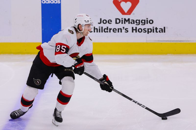 Apr 9, 2024; Sunrise, Florida, USA; Ottawa Senators defenseman Jake Sanderson (85) moves the puck against the Florida Panthers during the third period at Amerant Bank Arena. Mandatory Credit: Sam Navarro-USA TODAY Sports