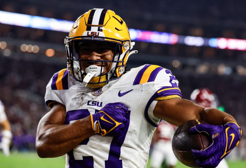 Nov 4, 2023; Tuscaloosa, Alabama, USA; LSU Tigers running back Josh Williams (27) carries the ball in for a touchdown against the Alabama Crimson Tide during the second half at Bryant-Denny Stadium. Mandatory Credit: Butch Dill-USA TODAY Sports