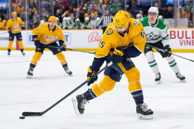 Feb 15, 2024; Nashville, Tennessee, USA; Nashville Predators defenseman Alexandre Carrier (45) skates with the puck  against the Dallas Stars during the first period at Bridgestone Arena. Mandatory Credit: Steve Roberts-USA TODAY Sports