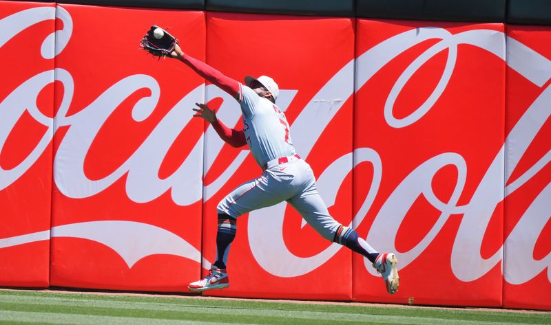 Jul 4, 2024; Oakland, California, USA; Los Angeles Angels right fielder Jo Adell (7) catches the ball against the Oakland Athletics during the third inning at Oakland-Alameda County Coliseum. Mandatory Credit: Kelley L Cox-USA TODAY Sports