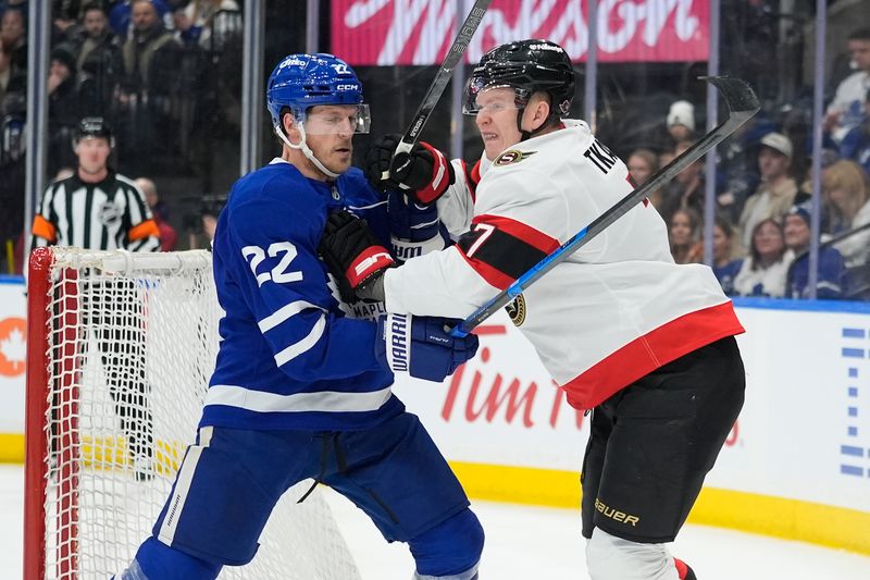 Dec 27, 2025; Toronto, Ontario, CAN; Toronto Maple Leafs defenseman Jake McCabe (22) and Ottawa Senators forward Brady Tkachuk (7) battle behind the net during the second period at Scotiabank Arena. Mandatory Credit: John E. Sokolowski-Imagn Images