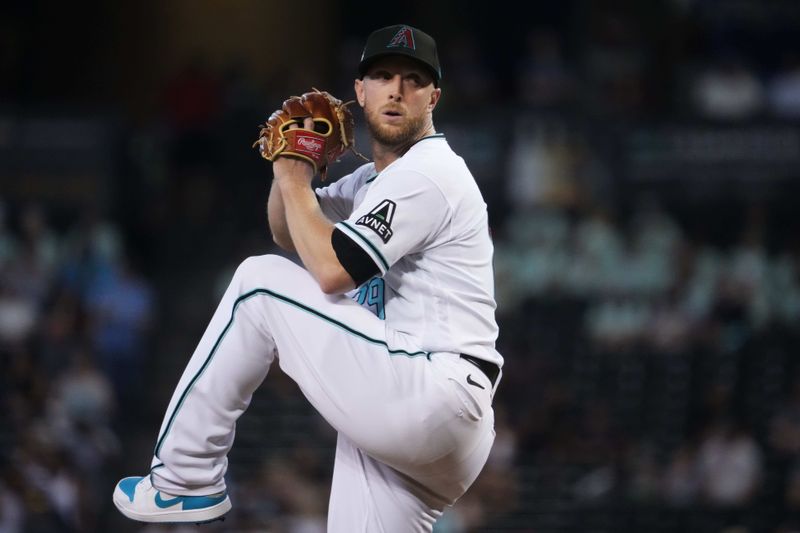 Jul 30, 2023; Phoenix, Arizona, USA; Arizona Diamondbacks starting pitcher Merrill Kelly (29) pitches against the Seattle Mariners during the first inning at Chase Field. Mandatory Credit: Joe Camporeale-USA TODAY Sports