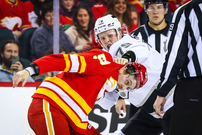 Nov 11, 2024; Calgary, Alberta, CAN; Calgary Flames center Justin Kirkland (58) and Los Angeles Kings center Samuel Helenius (79) fights during the second period at Scotiabank Saddledome. Mandatory Credit: Sergei Belski-Imagn Images